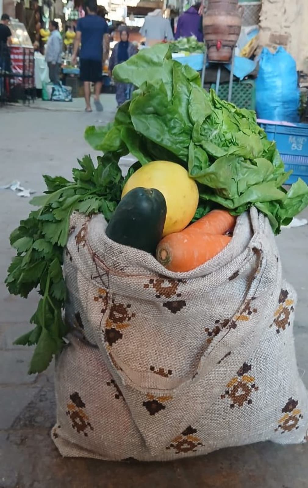 A hessian Small Sac packed with greens, carrots and squash at a medina market.